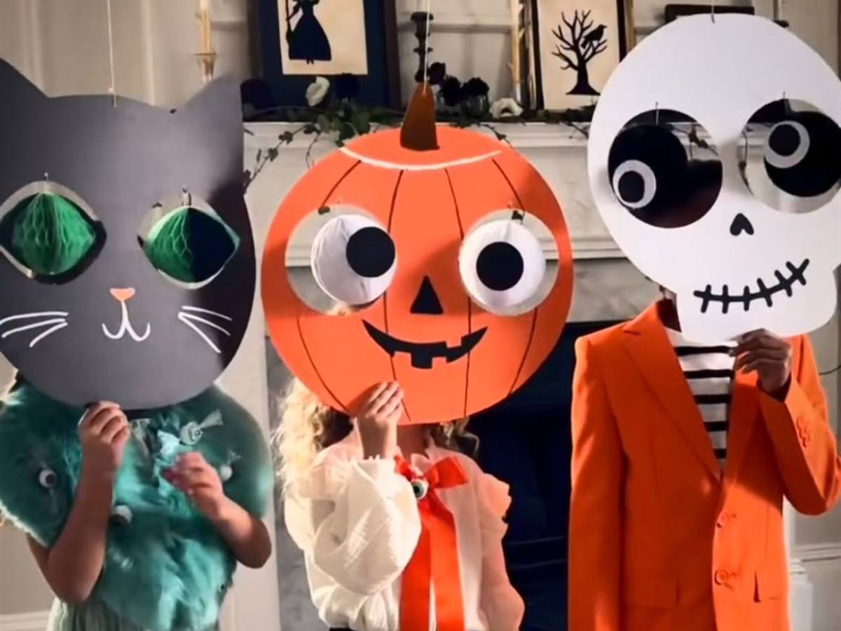 Tres niños disfrazados de gato, calabaza y calavera